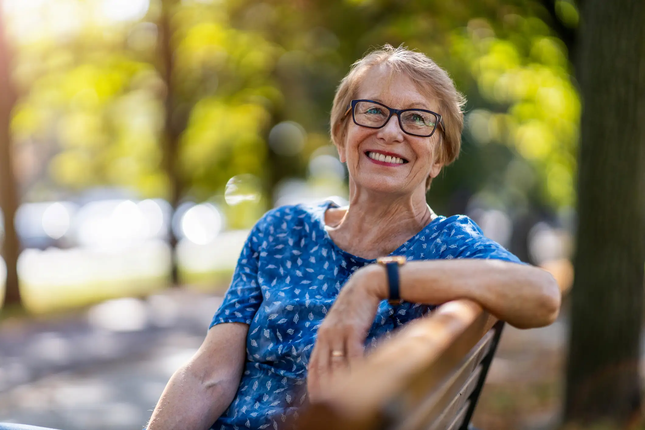 iStock-1276778124 senior woman sitting on a bench outdoors